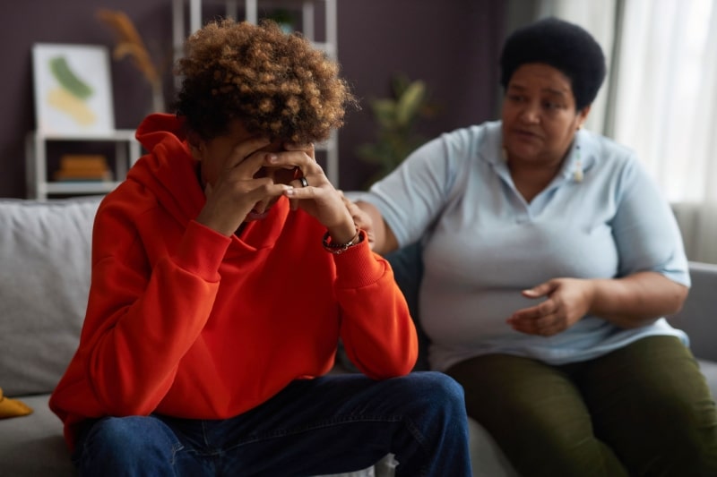 Grief Stricken Person Being Comforted on Couch