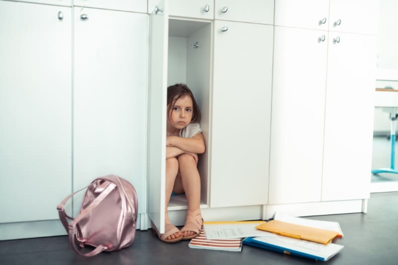 Student Sitting Inside Locker